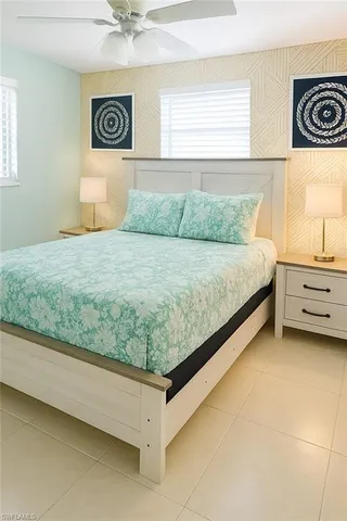 a bed sitting in a bedroom next to a window