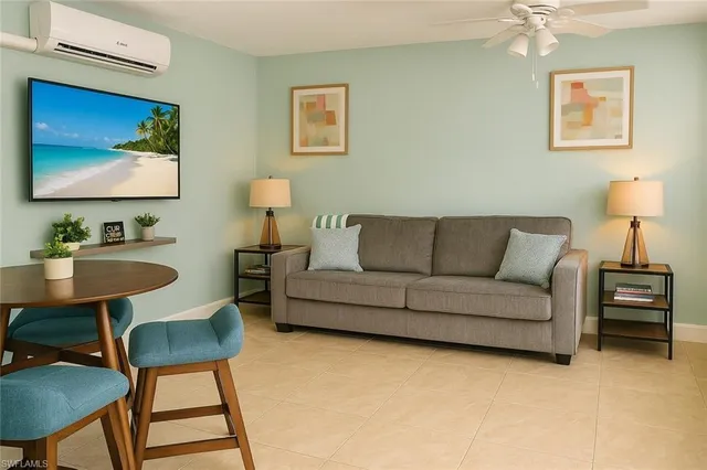 a living room with furniture a couch and a flat screen tv