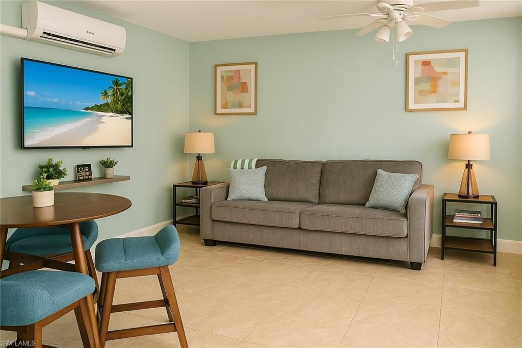 726 Park Avenue Naples, FL 34110 - Photo 9 of 32 a living room with furniture a couch and a flat screen tv