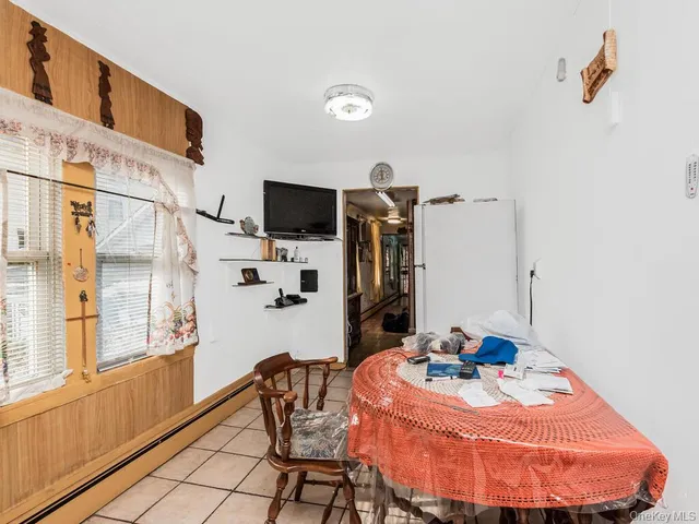 a dining room with furniture and a flat screen tv