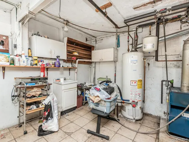 a storage room with stainless steel appliances kitchen island granite countertop furniture and a refrigerator