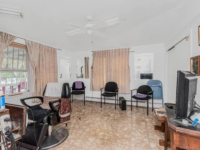 a living room with furniture a large window and a flat screen tv