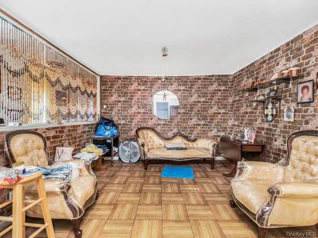 a living room with patio furniture and a rug