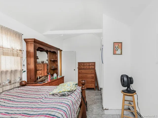 a bedroom with bed and a dresser