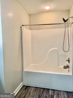 a bathroom with a shower and a bath tub