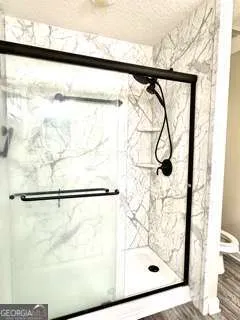 a bathroom with a shower and a window