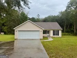 a view of a house with a yard and garage