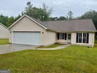 a front view of house with yard and green space