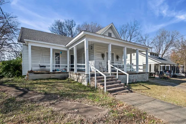 a view of a house with a yard balcony and sitting area