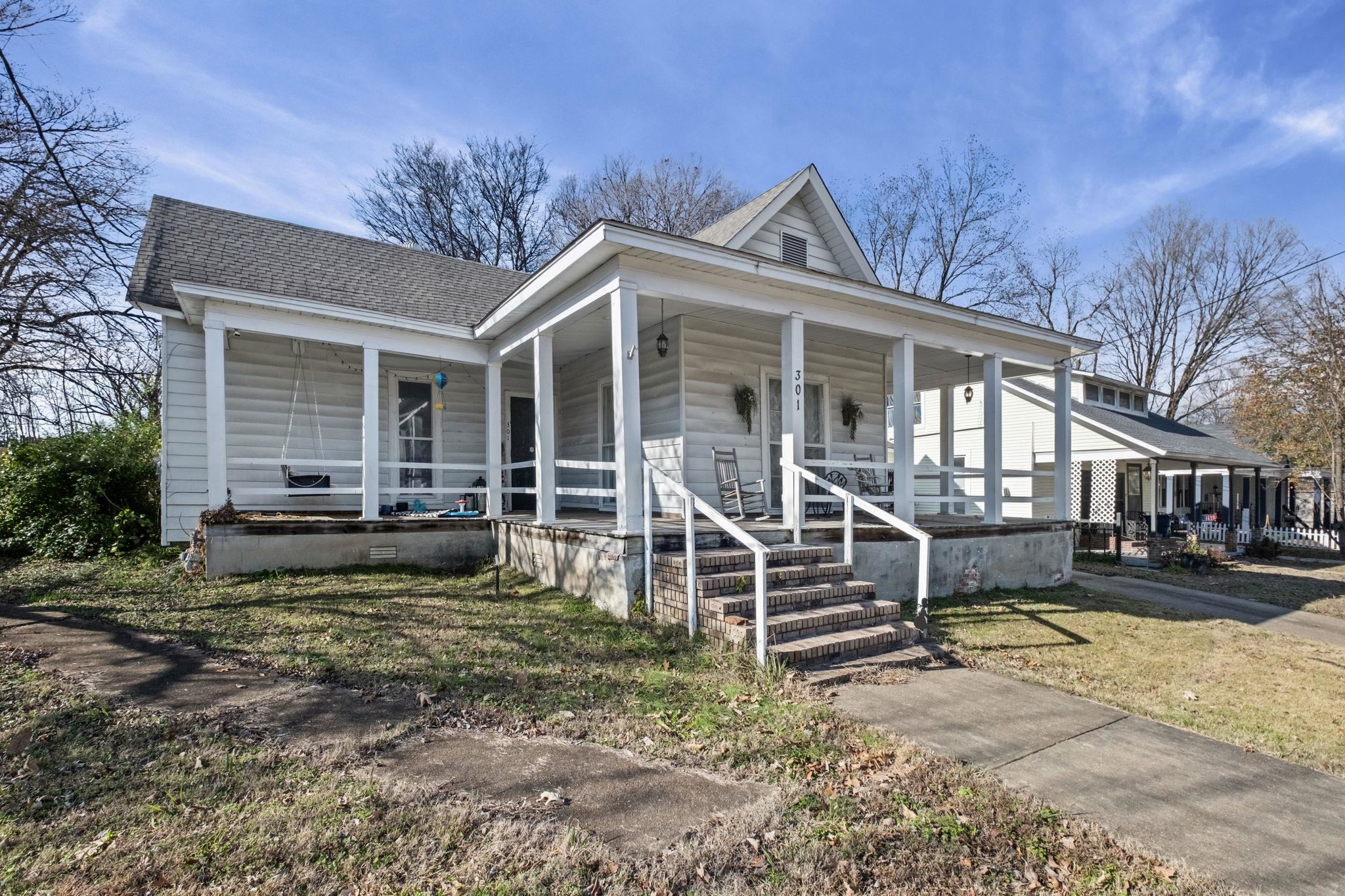 a view of a house with a yard balcony and sitting area