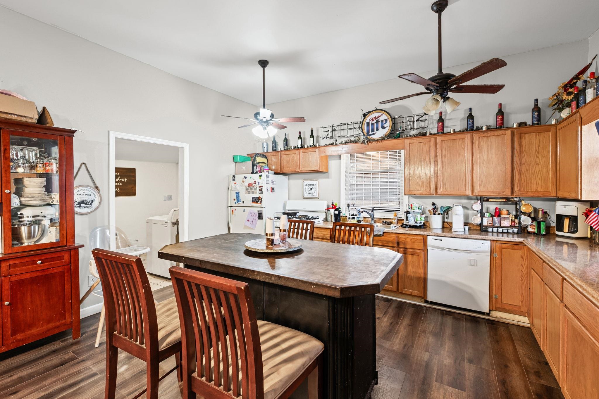 301 North Maple Street Covington, TN 38019 - Photo 15 of 26 a kitchen with granite countertop a table chairs stove and wooden floor