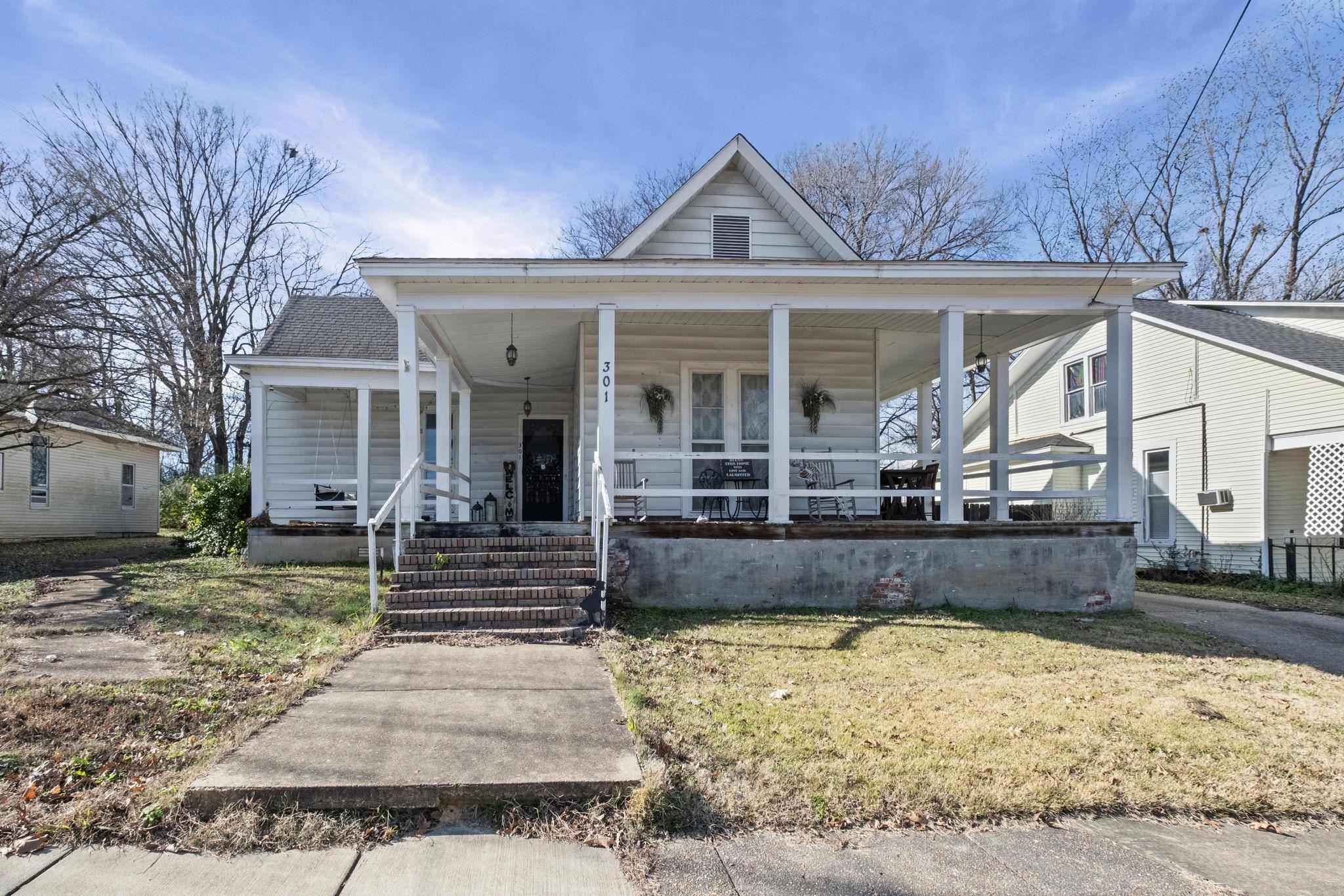 301 North Maple Street Covington, TN 38019 - Photo 2 of 26 a front view of a house with garden