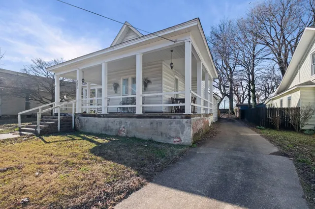 a view of a house with backyard and sitting area