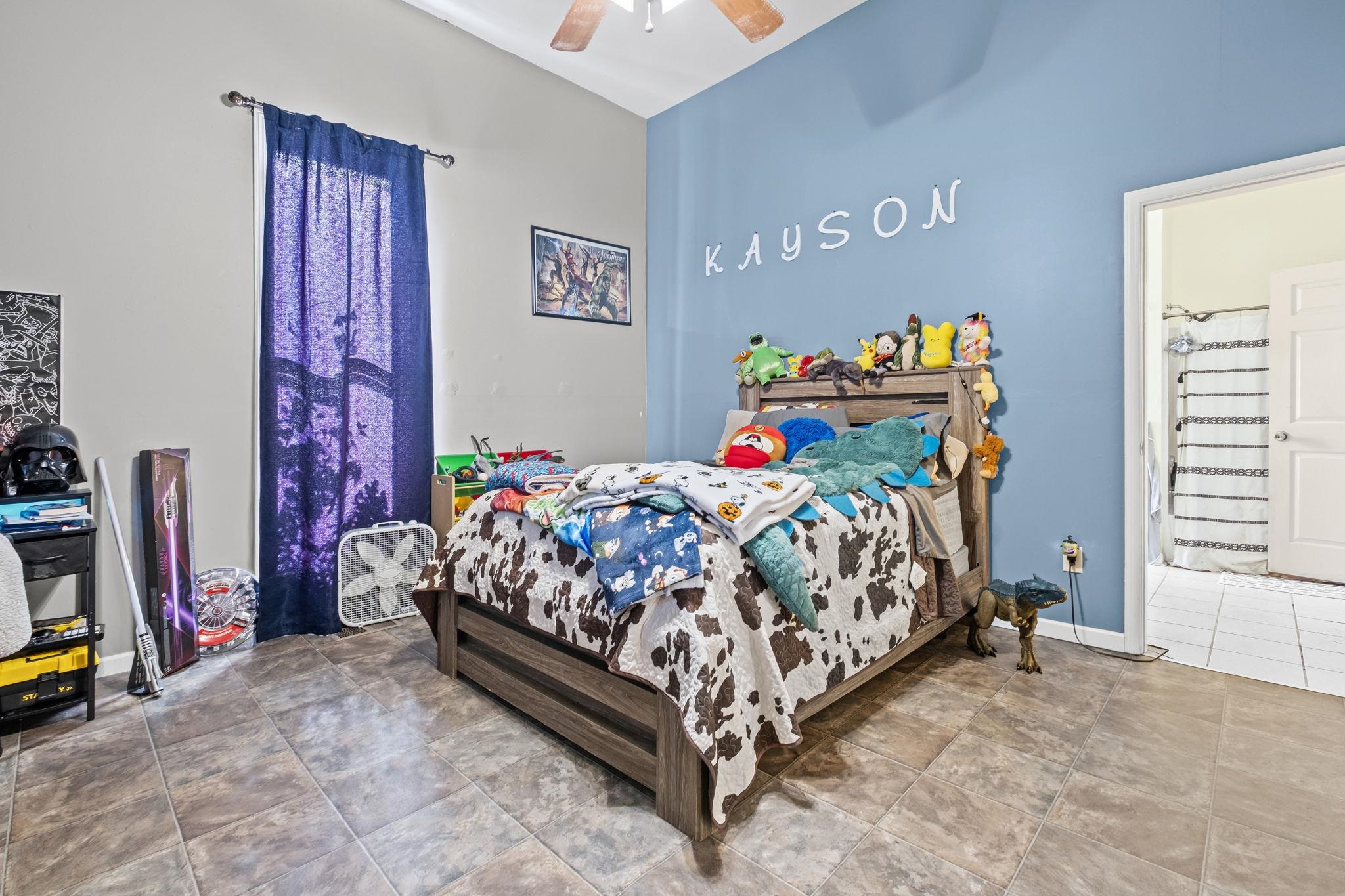 301 North Maple Street Covington, TN 38019 - Photo 9 of 26 a bed sitting in a bedroom next to a window