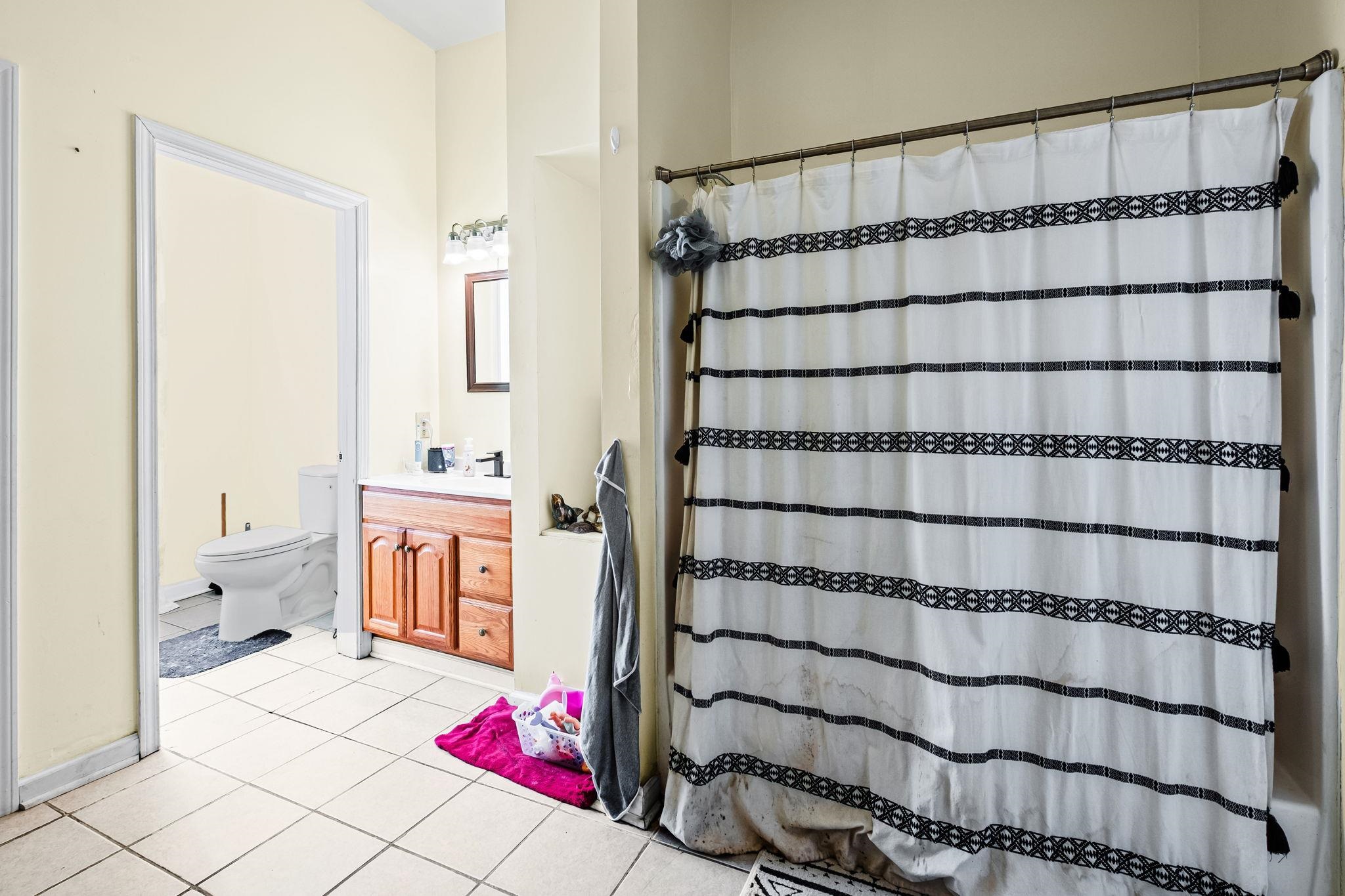 301 North Maple Street Covington, TN 38019 - Photo 10 of 26 a bathroom with a sink and a shower