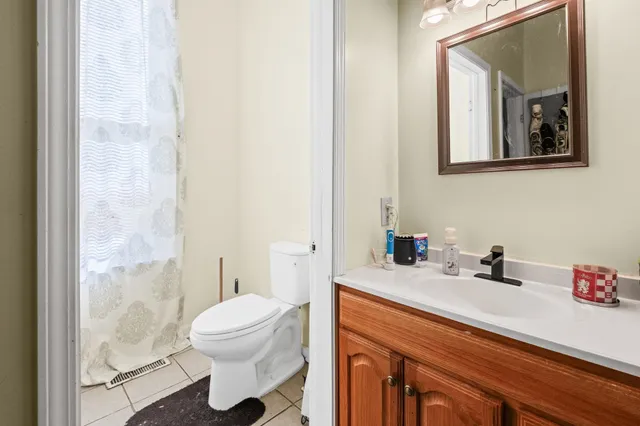 a bathroom with a sink a toilet and a mirror
