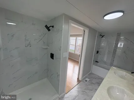 a bathroom with a sink and shower