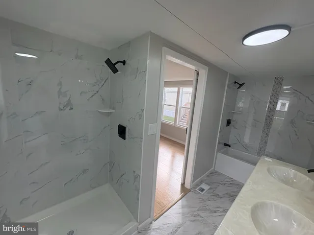 a bathroom with a sink and shower
