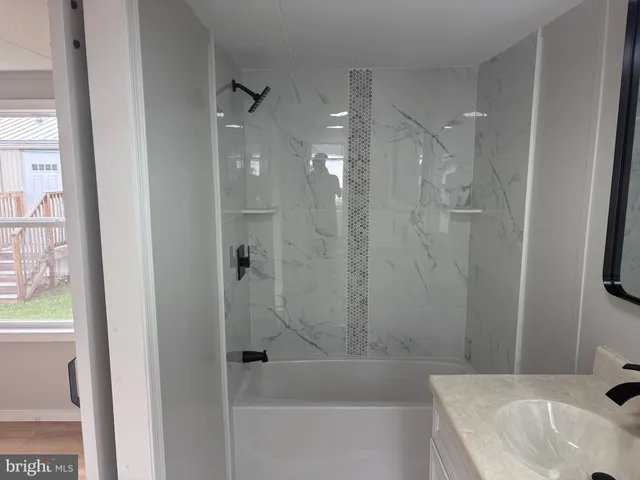 a bathroom with a bathtub and shower