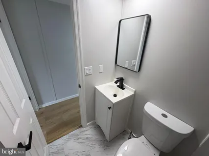 a bathroom with a toilet sink and mirror