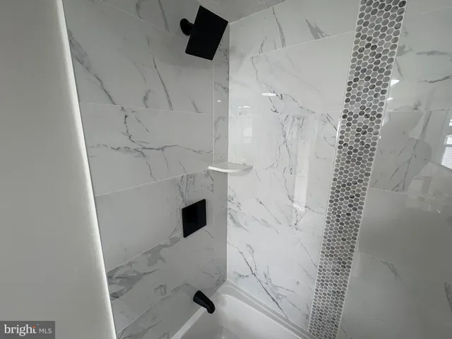 a bathroom with a shower and a sink