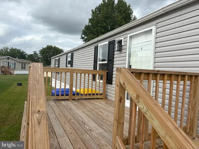 a view of balcony with wooden floor and fence