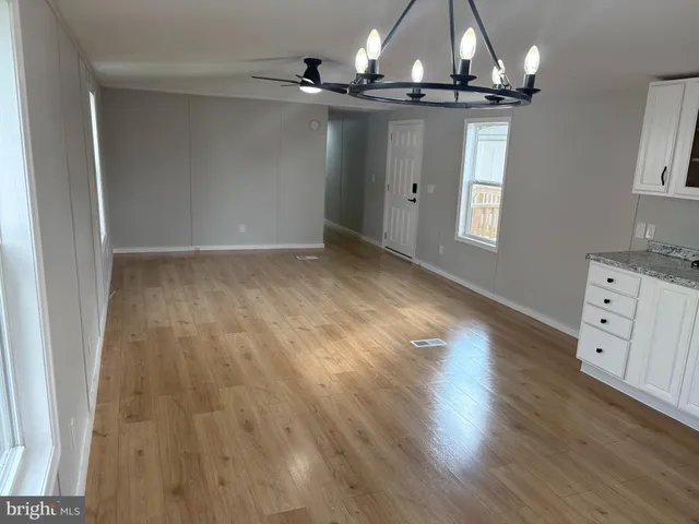 wooden floor in a hall with an empty room