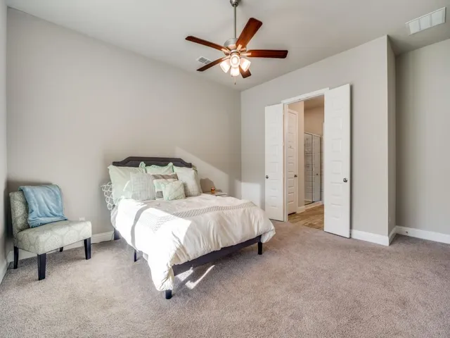 a spacious bedroom with a bed and a window