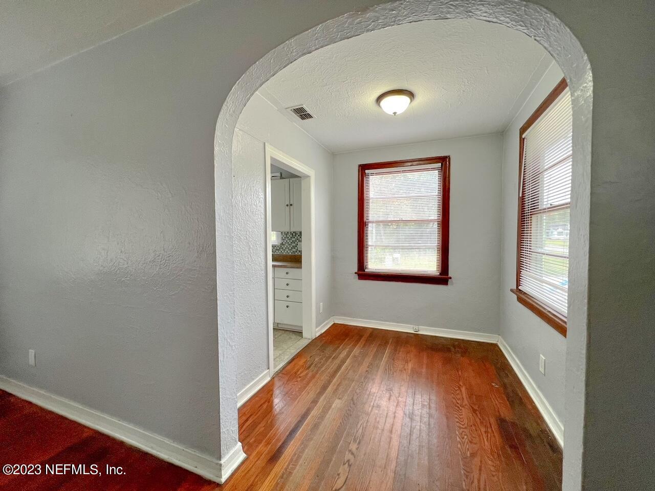 902 Nelson Street Jacksonville, FL 32205 - Photo 3 of 13 an empty room with wooden floor and windows