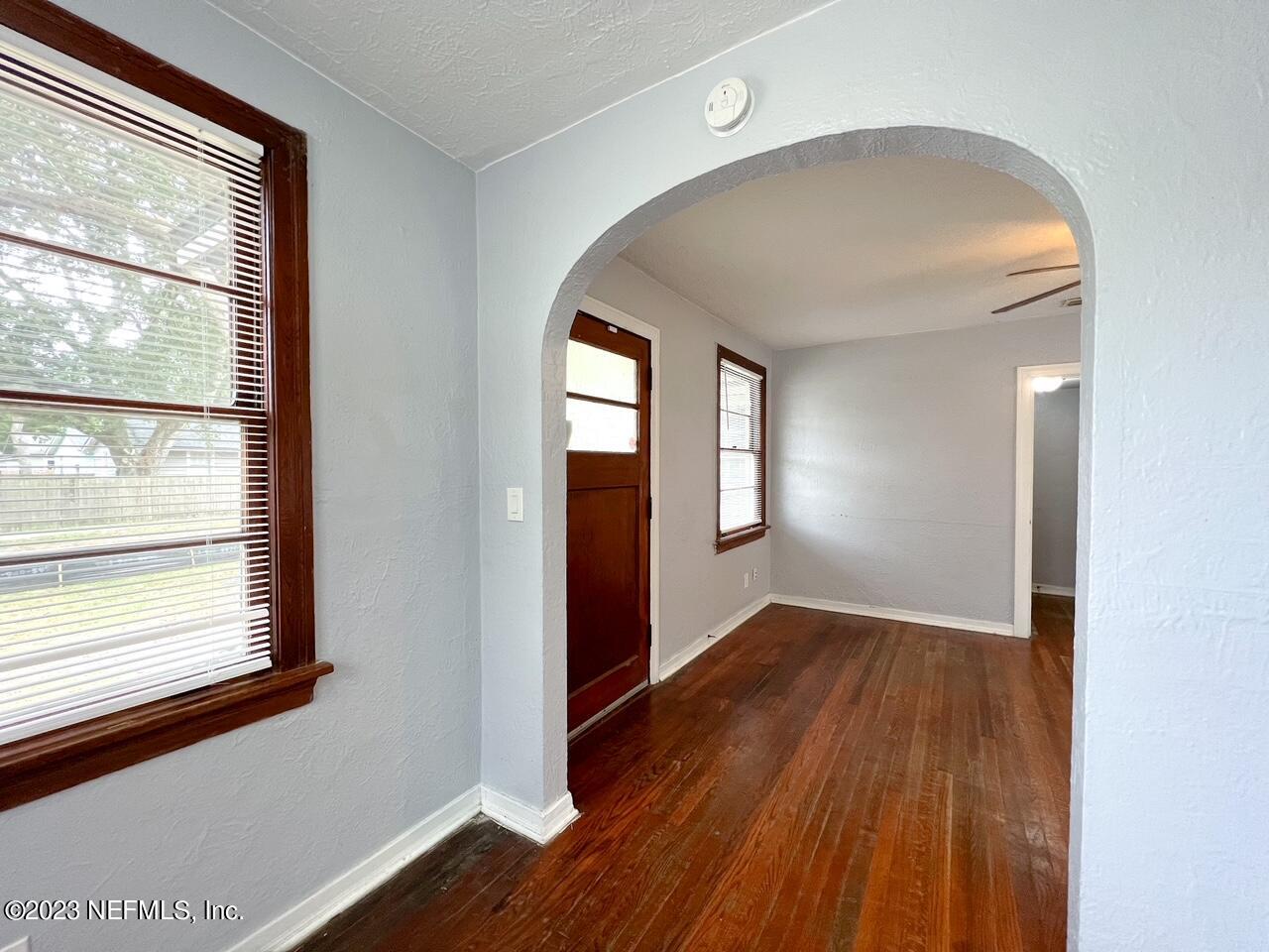 902 Nelson Street Jacksonville, FL 32205 - Photo 5 of 13 an empty room with wooden floor and windows
