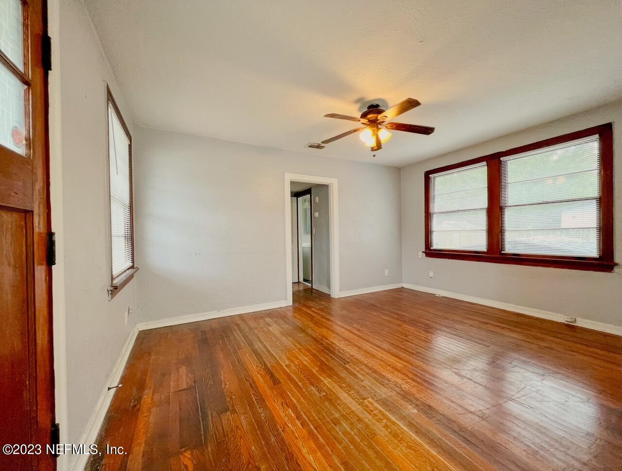 902 Nelson Street Jacksonville, FL 32205 - Photo 6 of 13 a view of empty room with wooden floor and fan