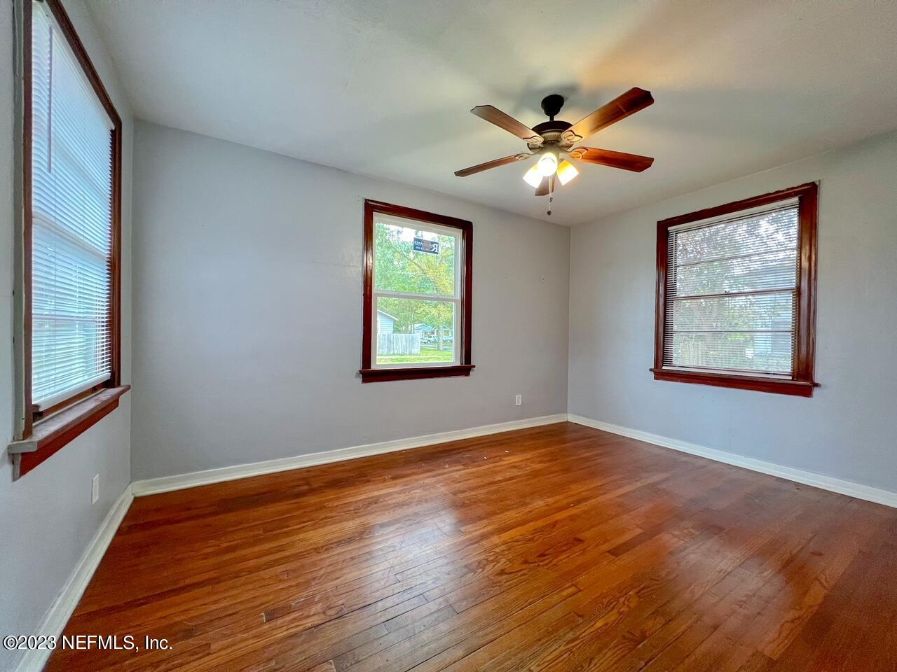 902 Nelson Street Jacksonville, FL 32205 - Photo 7 of 13 a view of an empty room with window and wooden floor