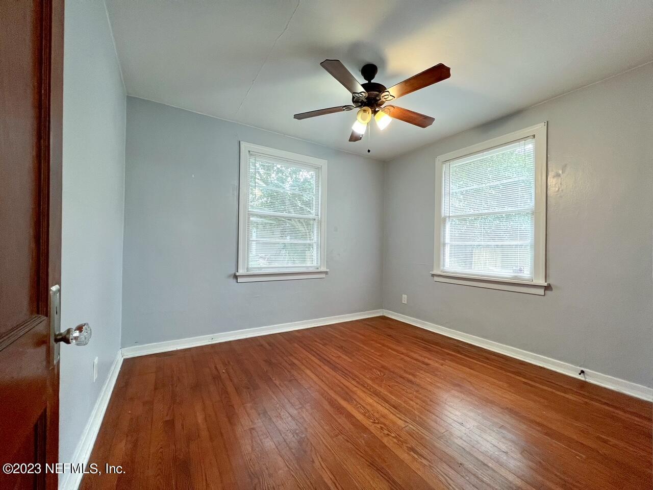902 Nelson Street Jacksonville, FL 32205 - Photo 10 of 13 a view of an empty room with wooden floor and a window