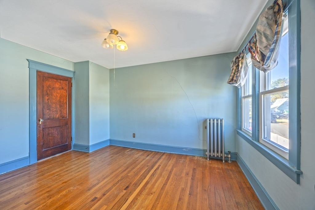 450 East Street Chicopee, MA 01020 - Photo 24 of 38 a view of an empty room with a window and wooden floor
