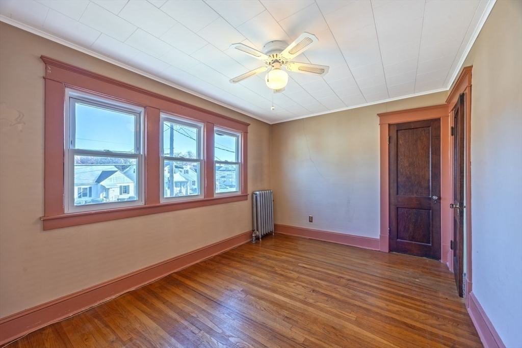 450 East Street Chicopee, MA 01020 - Photo 26 of 38 an empty room with wooden floor fan and windows
