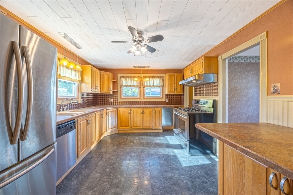 450 East Street Chicopee, MA 01020 - Photo 7 of 38 a kitchen with stainless steel appliances granite countertop a refrigerator a sink a stove and island