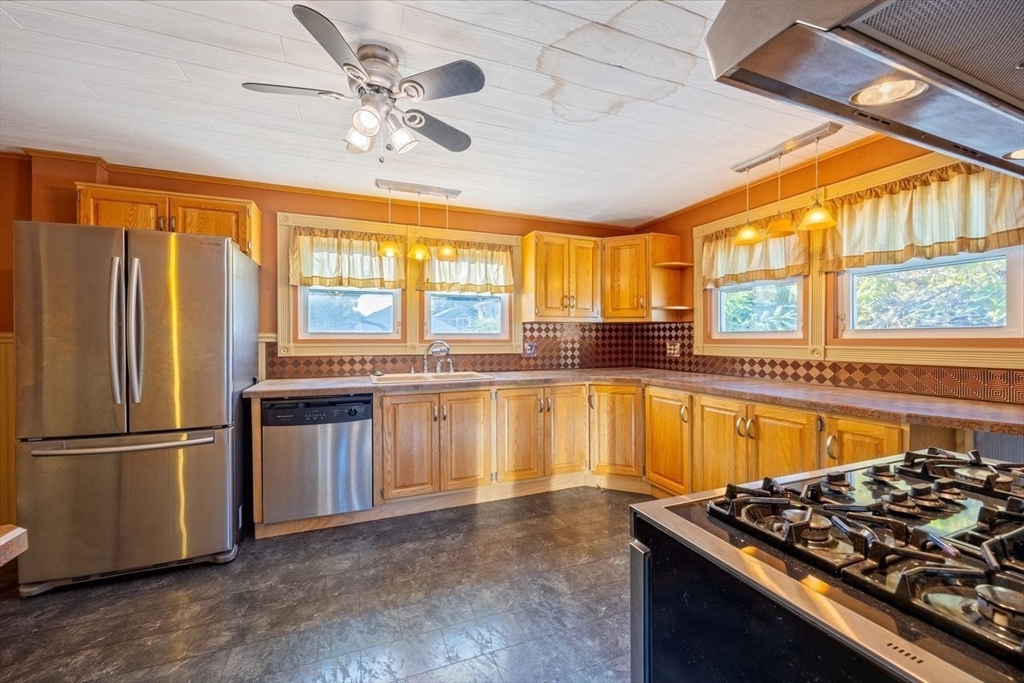 450 East Street Chicopee, MA 01020 - Photo 8 of 38 a kitchen with stainless steel appliances granite countertop a stove and a refrigerator