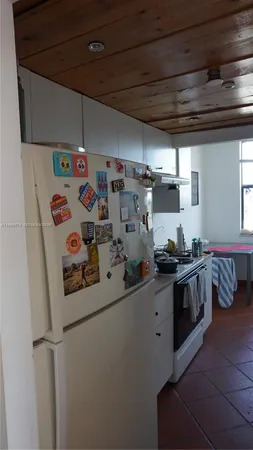 a kitchen with stainless steel appliances a sink a stove a refrigerator and cabinets