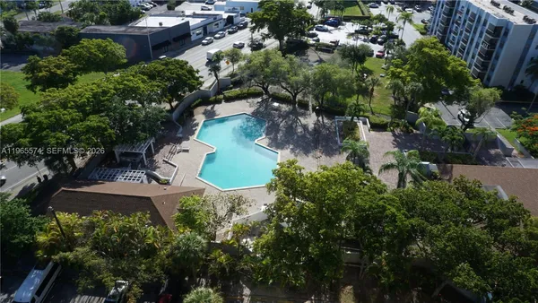 an aerial view of residential house with outdoor space and swimming pool