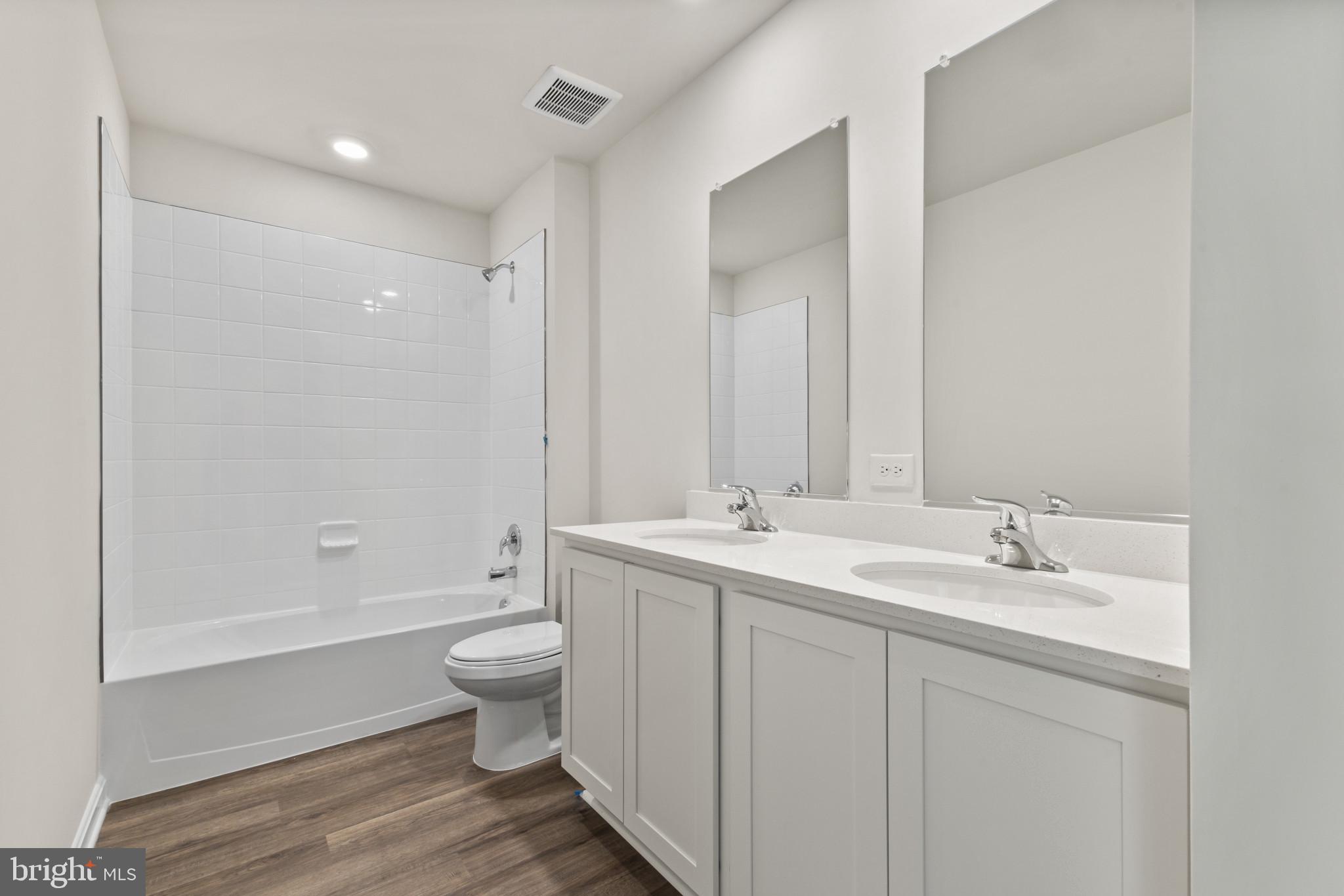 598 Atkinson Street Charles Town, WV 25414 - Photo 12 of 31 a bathroom with a double vanity sink toilet and shower