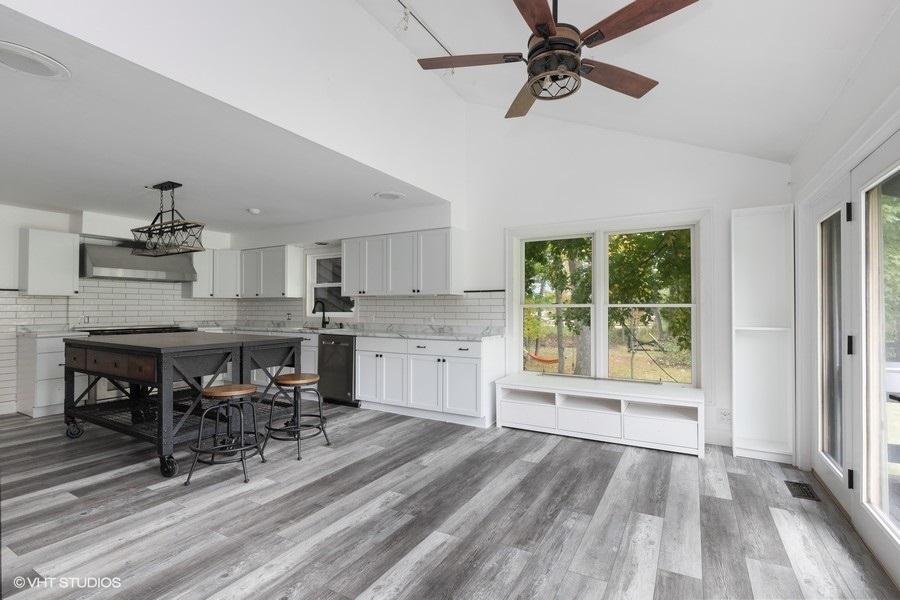 15141 West Little St Marys Road Mettawa, IL 60048 - Photo 31 of 42 a kitchen with stainless steel appliances kitchen island hardwood floor and wooden floors