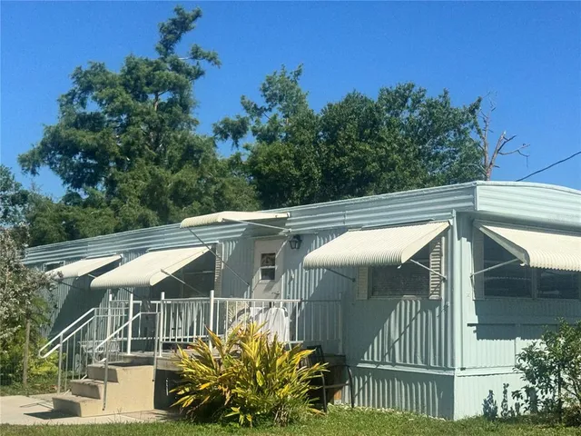 a view of a patio with a table and chairs under an umbrella