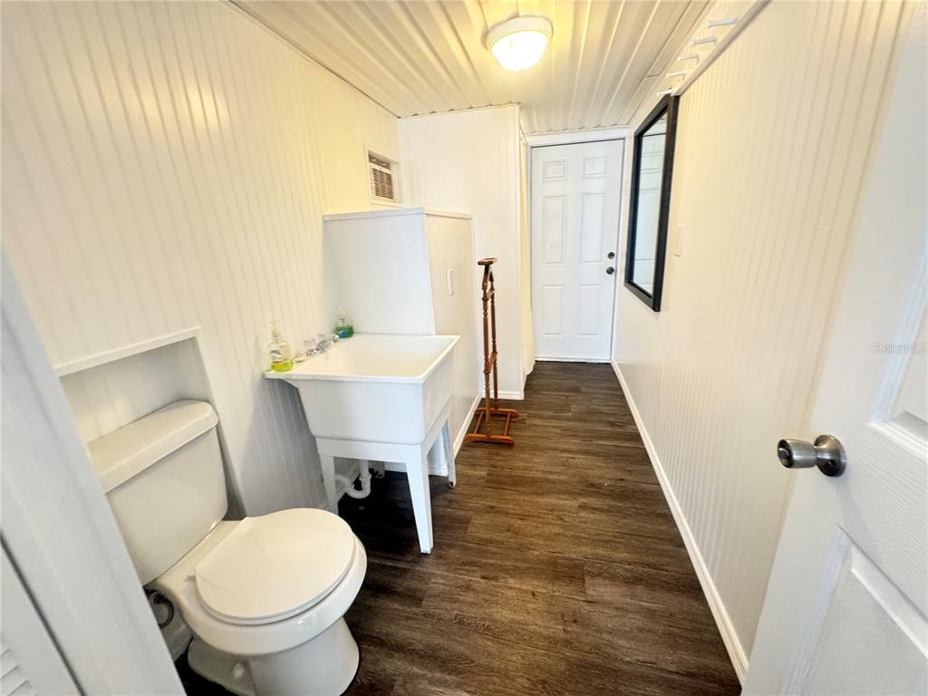 11970 Southwest Loop Terrace Arcadia, FL 34269 - Photo 12 of 37 a bathroom with a sink a toilet a mirror and vanity