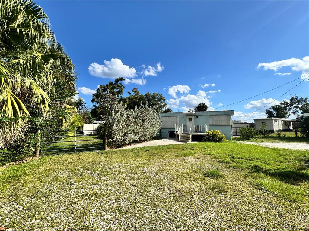11970 Southwest Loop Terrace Arcadia, FL 34269 - Photo 14 of 37 a view of a house with a yard and a garden
