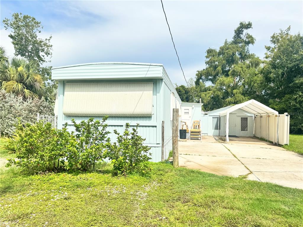 11970 Southwest Loop Terrace Arcadia, FL 34269 - Photo 23 of 37 a yellow house with trees in front of it