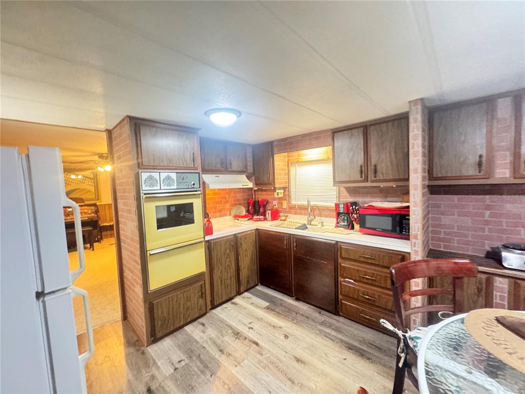 11970 Southwest Loop Terrace Arcadia, FL 34269 - Photo 5 of 37 a kitchen with stainless steel appliances kitchen island granite countertop a sink refrigerator and cabinets