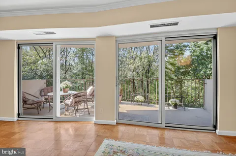 a balcony with wooden floor and outdoor seating