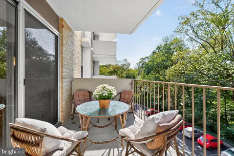 a balcony with table and chairs