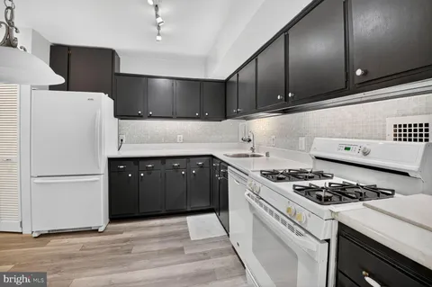 a kitchen with cabinets and appliances