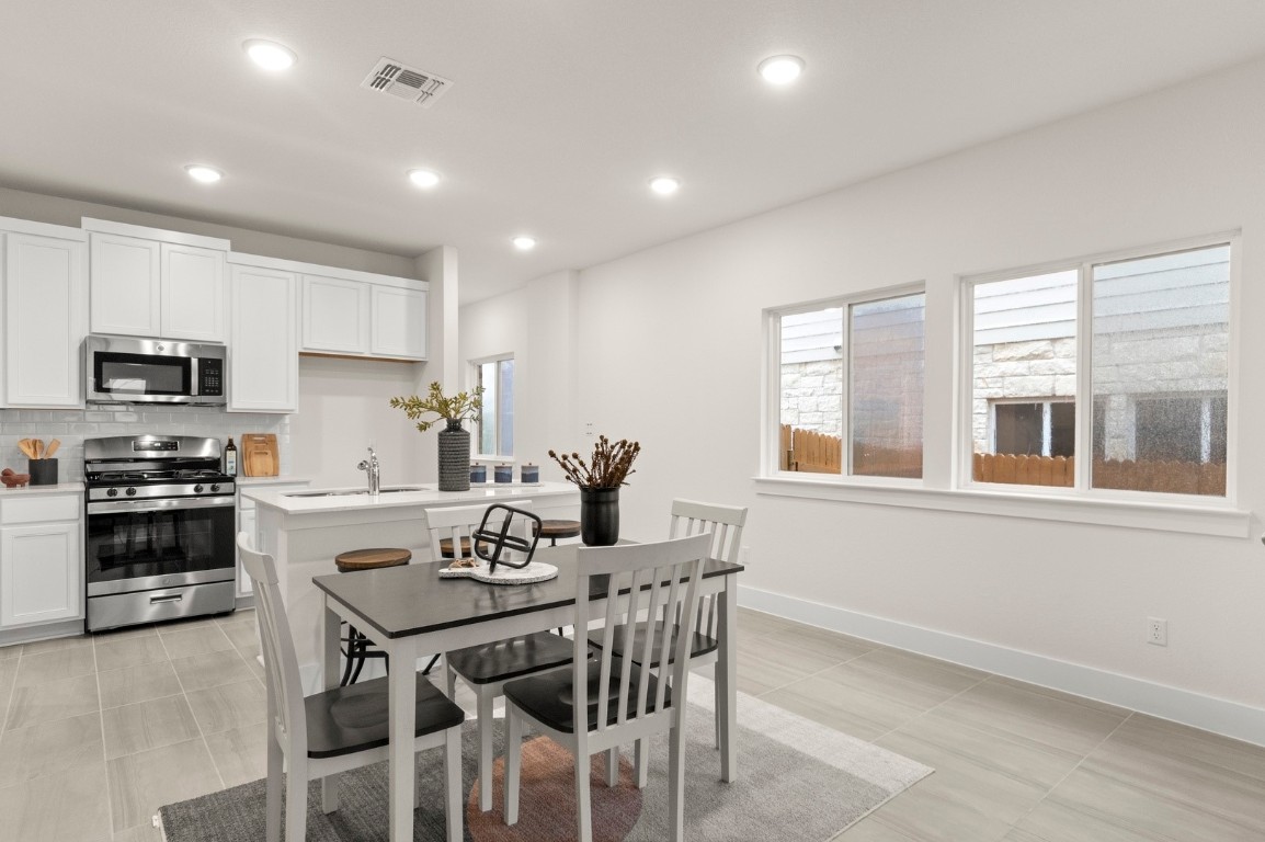 701 White Steppe Way Georgetown, TX 78626 - Photo 14 of 35 Dining area with recessed lighting and light tile patterned flooring